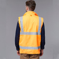 Back view of fluorescent orange safety vest with silver reflective tape and reversible polar fleece construction over navy sleeves