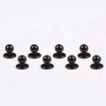Eight black dome-shaped chef buttons with flat circular bases arranged in two rows