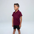 Maroon polo shirt with collar and short sleeves worn by child on neutral background