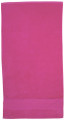 Hot pink cotton velour beach towel with plush textured surface
