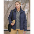 Woman wearing navy quilted puffer jacket with hood, front zip, and horizontal baffle panels, styled with grey polo and tan trousers