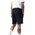 Rear view of black men's shorts with clean flat back panel, mid-thigh length, worn with white tee and socks