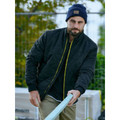Man wearing black diamond quilted bomber jacket with yellow zip contrast, ribbed cuffs, outdoor worksite setting