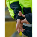 Close-up of fluoro yellow and navy hi vis hoodie cuff with thumb hole detail and reflective tape on sleeve