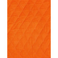 Close-up of tangerine orange quilted lining panel with diamond stitch pattern from a hi vis drill jacket