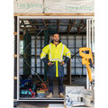 High visibility rain jacket in fluorescent yellow with navy contrast panels and reflective tape detailing