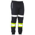 Black tapered track pants with silver reflective tape at thighs and hi-vis yellow and silver tape at calves