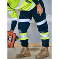 Navy work pants with silver and yellow-lime reflective tape stripes on legs, paired with hi-vis safety jacket
