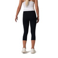 Black high-rise capri leggings with white crop top, rear view showing fitted silhouette and mid-calf length