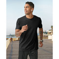 Man jogging outdoors in a black crew neck performance tee with smooth flat front panel, coastal boardwalk setting