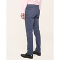 Man wearing slate blue slim-fit chino pants with five-pocket jean styling, paired with a pink shirt and black monk-strap shoes, rear view
