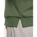 Olive green sweater hem with ribbed cuffs and side split detail over grey sweatpants