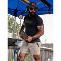 Man wearing black cotton crew neck tee with yellow-green Bisley outline chest print, paired with stone shorts outdoors