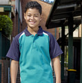 Kids raglan polo shirt in aqua blue body with navy sleeves and white contrast panels at shoulders