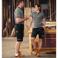 Black cargo work shorts with reinforced knee panels and utility pockets in stretch fabric