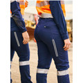 Women wearing navy stretch ripstop cargo pants with reflective tape bands and zip pockets at a worksite