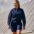 Woman wearing navy ripstop cargo shorts with matching work shirt, walking beside solar panels outdoors