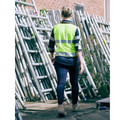 Woman walking through worksite in lime yellow and navy hi vis long sleeve polo with reflective tape