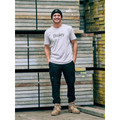 Navy stretch denim cargo pants with cuffed hems and multiple utility pockets worn with white tee and beanie