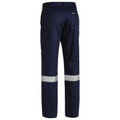 Navy work pants rear view showing twin silver reflective tape bands at lower leg and back pocket