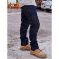 Dark indigo denim work jeans with multi-pocket cargo styling and knee panel articulation