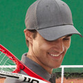 Grey athletic cap with laser-cut perforated side panels and structured six-panel crown with curved peak