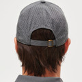 Charcoal grey cap with laser-cut perforations throughout, rear view showing adjustable metal buckle closure