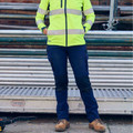Navy cargo pants with knee articulation and multiple pockets paired with hi-vis safety yellow jacket