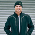 Man wearing black rib knit beanie with folded cuff and yellow Bisley logo embroidery
