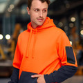 Fluorescent orange and navy two-tone fleece hoodie with contrast sleeves and utility pocket detail