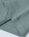 Close-up of sage green premium crew neck tee showing clean hem stitching and smooth cotton fabric