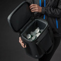 Charcoal black structured cooler bag held open to reveal iced cans inside, rigid lid and padded exterior panels