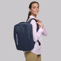 Model wearing navy blue water resistant laptop backpack with front zip pocket and padded shoulder straps