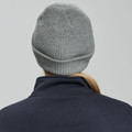 Grey marle cable knit beanie with rolled cuff shown from behind on model