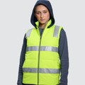 Hi-vis yellow puffer vest with reflective silver tape and front zip worn over navy hooded sweatshirt