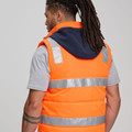 Unisex High Visibility Hooded Puffer Vest featuring a quilted thermal lining, reflective safety tape, and a detachable hood for warmth and visibility in cold outdoor work environments. High-Visibility Hooded Puffer Vest - Orange Navy