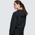 Black waterproof performance jacket with hood shown from back, featuring smooth finish and raglan sleeves