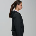 Female model in profile wearing a black hooded waterproof jacket with smooth shell finish over a pink collar