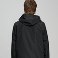 Rear view of black hooded waterproof jacket with smooth panelled back, worn by male model