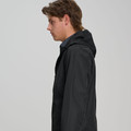 Male model wearing a black hooded waterproof jacket with smooth shell fabric, shown from the side