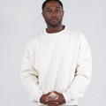 Cream oversized crew neck sweater with dropped shoulders and relaxed fit on model