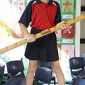 Navy box-pleat school shorts with red and navy contrast panel polo shirt featuring white shoulder panels