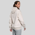Back view of cream oversized fleece hoodie with hood up, ribbed cuffs and hem
