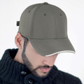 Olive green cap with white contrast piping along curved brim, structured six-panel crown with embroidered eyelets