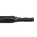 Close-up of folded black premium umbrella with textured rubber grip handle and subtle diagonal weave canopy fabric