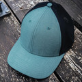 Teal front panel and visor trucker cap with black mesh back and contrast top button