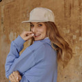 White organic cotton flat peak snapback cap with structured front panel and adjustable closure