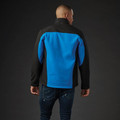 Rear view of men's softshell jacket in cobalt blue and black two-tone panelling worn with jeans