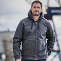 Man wearing charcoal cotton canvas zip-up hoody with drawstring hood and front kangaroo pocket at harbour