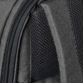 Close-up of charcoal backpack showing coil zipper detail, woven outer fabric and open-mesh interior lining